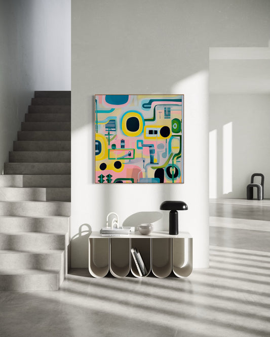 SOFT SYSTEMS – LOOP fine art print by Australian artist Ash Badios, featuring colourful abstract geometric forms, circular shapes and interconnected lines in pink, turquoise, yellow and green, displayed above a sculptural white console beside a concrete staircase in a light-filled contemporary entryway.